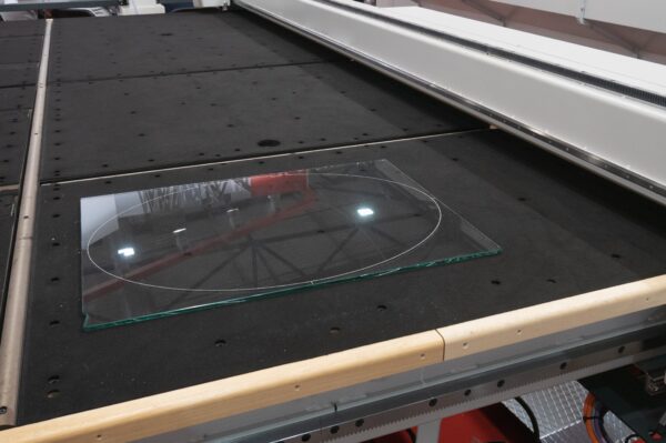 Photo of a piece of glass on a laser glass etching machine