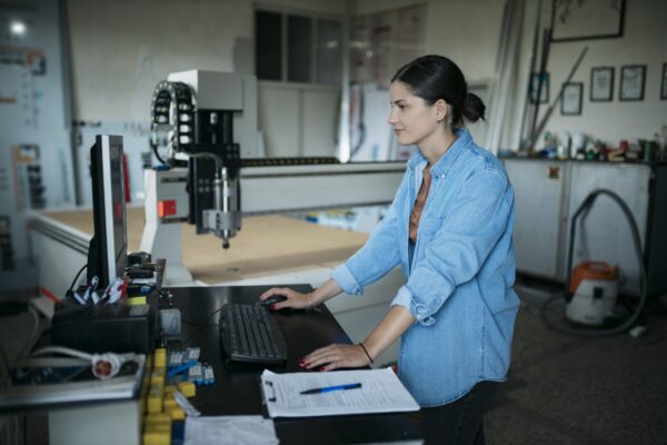 Photo of woman learning artwork on the laser machine