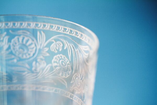 Photo of a glass that has etching along the edge